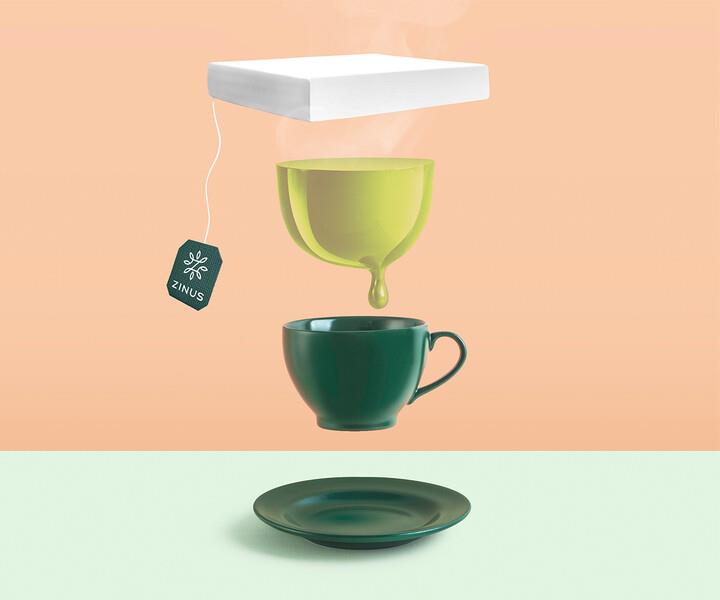Playful Zinus concept image showing a floating mattress above a teacup and saucer with a Zinus tea tag, symbolizing freshness, calm, and green tea–infused memory foam comfort