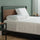 Zinus Modern platform bed with wood headboard, white bedding, and simple bedside table accents.