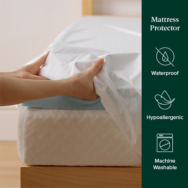 Hands stretching a waterproof, hypoallergenic mattress protector over a bed, showing its snug fit and machine washable design