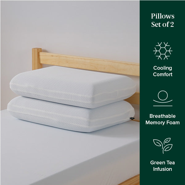 Two white memory foam pillows stacked on a twin bed, highlighting breathable, cooling comfort and green tea infusion benefits.