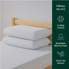 Two white memory foam pillows stacked on a twin bed, highlighting breathable, cooling comfort and green tea infusion benefits.