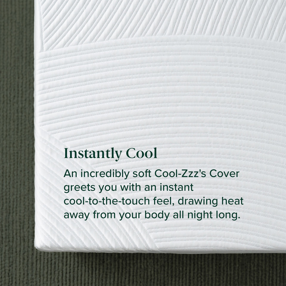 Zinus Balanced Comfort Luxe Memory Foam Mattress, close-up of the quilted Cool-Zzz's top cover texture with wave-pattern stitching, labeled 'Instantly Cool' with supporting text: 'An incredibly soft Cool-Zzz's Cover greets you with an instant cool-to-the-touch feel, drawing heat away.