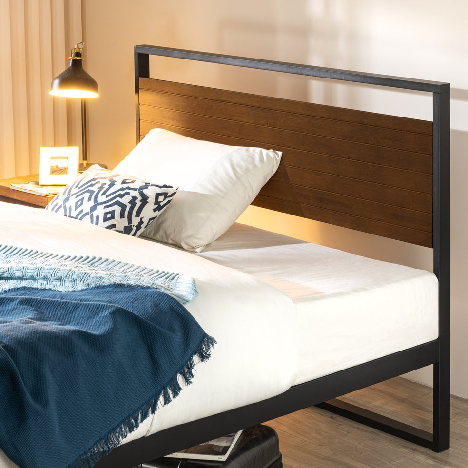 Zinus Suzanne Metal and Bamboo Platform Bed Frame shown in a modern bedroom with brown steel frame and natural bamboo headboard. Durable wood slats provide reliable mattress support while the minimalist design enhances style and functionality