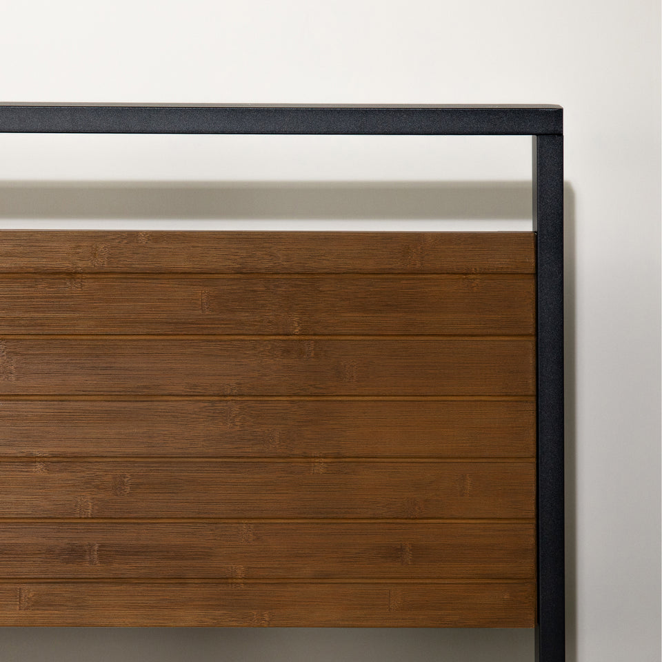 Close-up of Zinus Suzanne Platform Bed Frame headboard featuring natural bamboo panels and sleek brown steel frame. The clean-lined design highlights modern craftsmanship, blending durability with a warm, minimalist aesthetic.