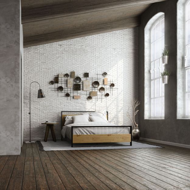 Zinus Suzanne Metal and Bamboo Platform Bed Frame styled in a modern loft bedroom with exposed brick wall. Black steel frame with bamboo headboard and footboard blends industrial and natural elements for timeless design and durability.