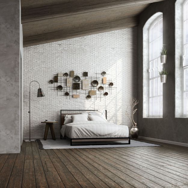 Zinus Suzanne Metal and Bamboo Platform Bed Frame styled in an industrial loft bedroom with white brick walls, wood floors, and large windows. Features bamboo headboard and footboard framed in black steel with durable wood slat support.