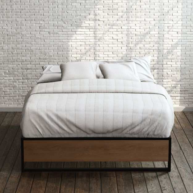 Zinus Suzanne Metal and Bamboo Platform Bed Frame in queen size, styled with white bedding against a brick wall backdrop. Black steel frame with bamboo accent panel and slatted base offers sturdy support and a clean, modern look for any bedroom.