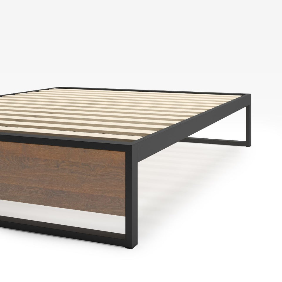 Close-up of Zinus Suzanne Metal and Bamboo Platform Bed Frame corner detail. Shows black steel frame construction, bamboo wood accent, and slatted mattress base. Sturdy design built for long-lasting durability and modern bedroom style