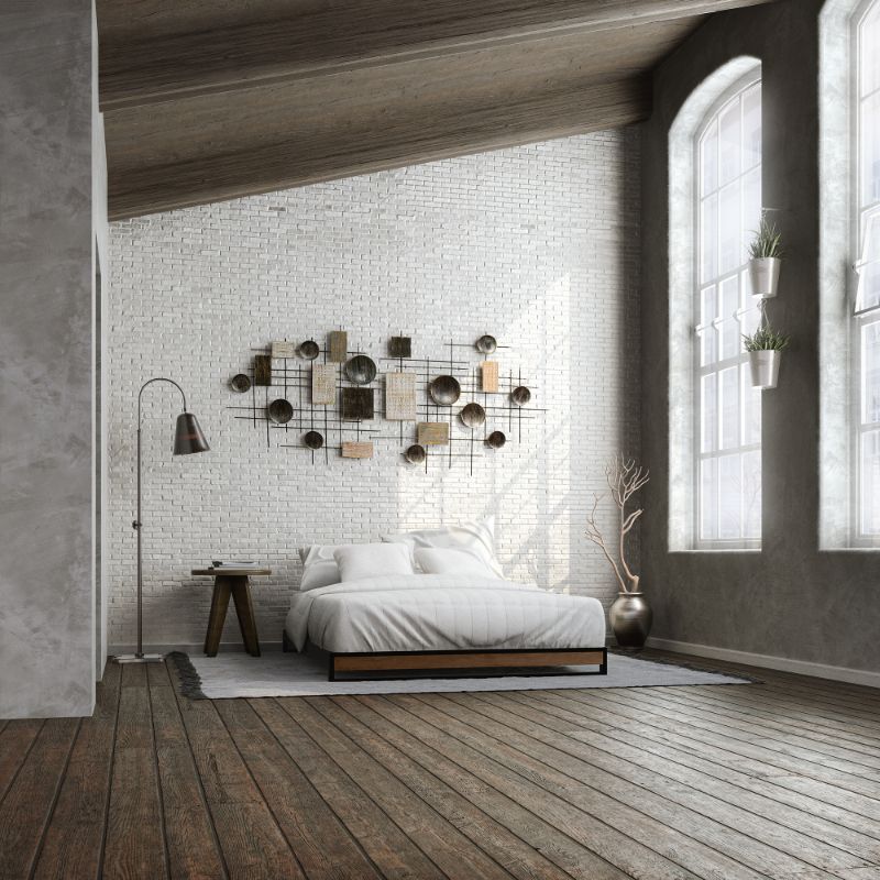 Zinus Suzanne Metal and Bamboo Platform Bed Frame styled in a loft bedroom with white brick walls. Black steel frame with bamboo accents and wood slats creates a modern industrial look, supporting a neatly dressed bed with white bedding.